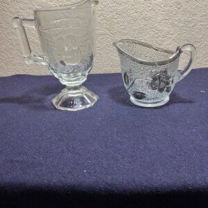 Two Vintage Cream Pitchers Jeannette Baltimore Pear an a silver overlay creamer.